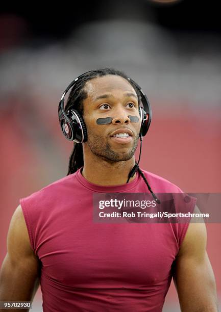 Larry Fitzgerald of the Arizona Cardinals listens to music on his headphones before a game against the Green Bay Packers in the NFC wild-card playoff...