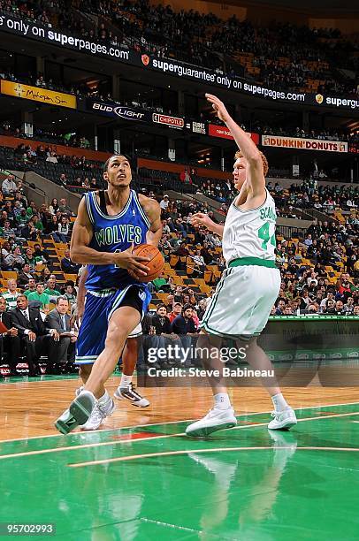 Ryan Hollins of the Minnesota Timberwolves drives around Brian Scalabrine of the Boston Celtics during the game on December 20, 2009 at the TD Garden...