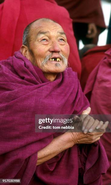 Close-up of an elderly monk as he clasps his hands at the Ta'er lamasery, Qinghai province, China, April 1980.