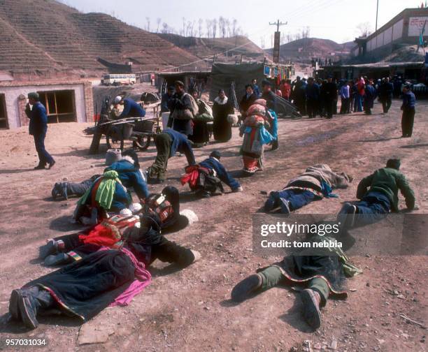 Worshippers lay prostrate on the ground as they pray at the Ta'er lamasery, Xining, Qinghai province, China, April 1980.