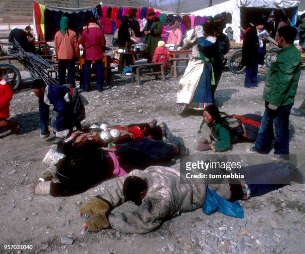 Worshippers lay prostrate on the ground as they pray at the Ta'er lamasery, Xining, Qinghai province, China, April 1980.