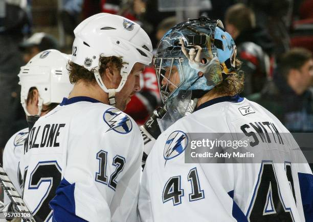 Ryan Malone of the Tampa Bay Lightning congratulates winning goaltender Mike Smith after he defeated the New Jersey Devils during the continuation of...