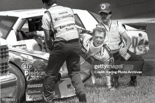 Buddy Baker crashes on the 243rd lap of the Coca-Cola 600. He is seen here crawling out of his car. Baker would take home $5,350 for the day.