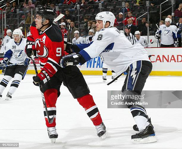 Matt Walker of the Tampa Bay Lightning puts his stick in the back of Zach Parise of the New Jersey Devils during the continuation of the game from...