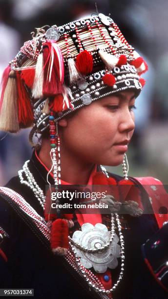 Close-up of a Kuchong girl dressed in traditional clothing, Xishuangbanna, Yunnan province, China, April 1980.