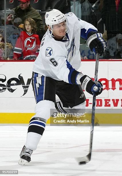 Kurtis Foster of the Tampa Bay Lightning fires a shot in warmups prior to the start of the continuation of the game against the New Jersey Devils...