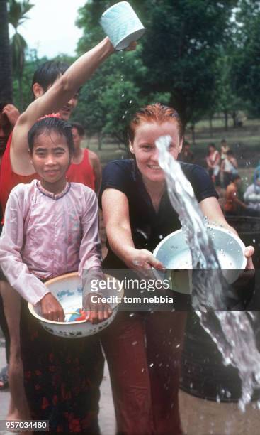 During the Water Splashing festival, Gitte Nebbia throws water towards the camera, Xishuangbanna, Yunnan province, China, April 1980.