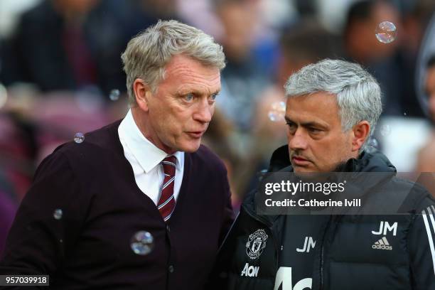 David Moyes, Manager of West Ham United and Jose Mourinho, Manager of Manchester United speak prior to the Premier League match between West Ham...