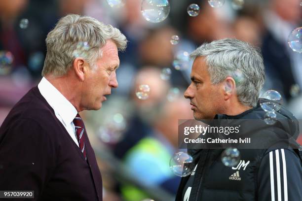 David Moyes, Manager of West Ham United and Jose Mourinho, Manager of Manchester United speak prior to the Premier League match between West Ham...