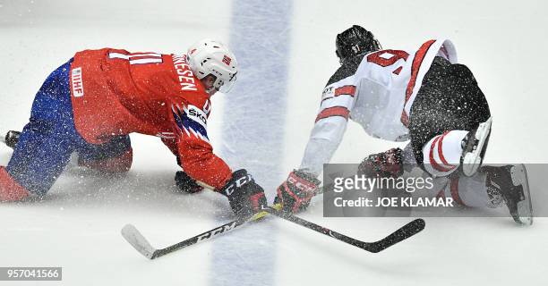 Norway's Johannes Johannesen challenges for the puck with Canada's Connor McDavid during the group B match Norway vs Canada of the 2018 IIHF Ice...