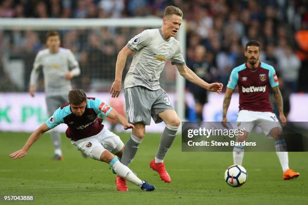 Aaron Cresswell of West Ham United gets tackled by Scott McTominay of Manchester United during the Premier League match between West Ham United and...