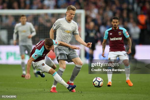 Aaron Cresswell of West Ham United gets tackled by Scott McTominay of Manchester United during the Premier League match between West Ham United and...