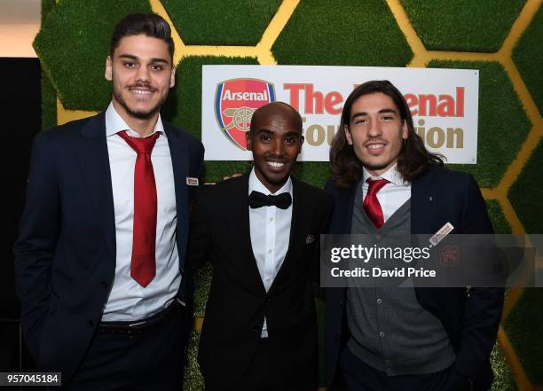 Hector Bellerin and Konstantinos Mavropanos of Arsenal with Athlete Mo Farah at the Arsenal Foundation Charity Ball at Emirates Stadium on May 10,...