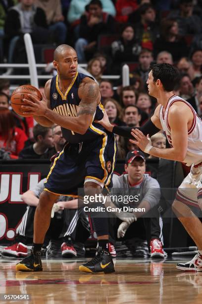 Dahntay Jones of the Indiana Pacers handles the ball against Kirk Hinrich of the Chicago Bulls during the game on December 29, 2009 at the United...