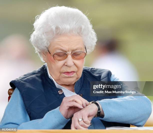 Queen Elizabeth II watches her horse 'Sparkler' compete in the Flat Ridden Sport Horse class on day 1 of the Royal Windsor Horse Show in Home Park on...