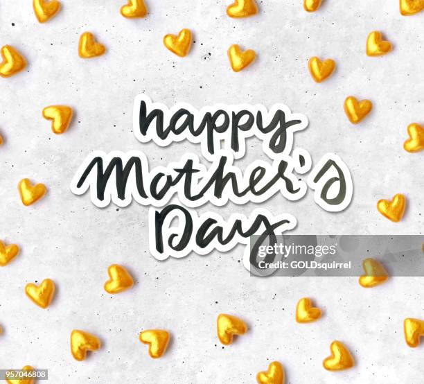 hand-made composition of gold and red hearts with handwritten text happy mothers day - beautiful original love card design - beton background stock illustrations