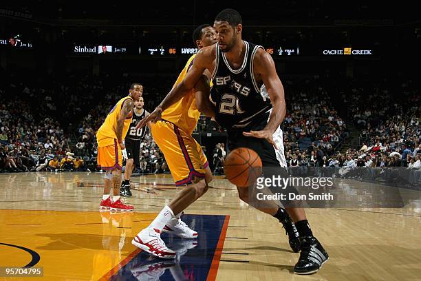 Tim Duncan of the San Antonio Spurs drives the ball past Brandan Wright of the Golden State Warriors during the game on December 16, 2009 at Oracle...