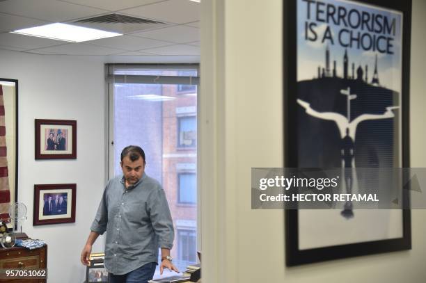 Former FBI Agent Ali Soufan walks in his office during an interview with AFP in New York City, on April 23, 2018. - To television viewers, he is the...