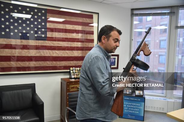 Former FBI Agent Ali Soufan holds an old FBI weapon during a interview with AFP in New York City, on April 23, 2018. - To television viewers, he is...