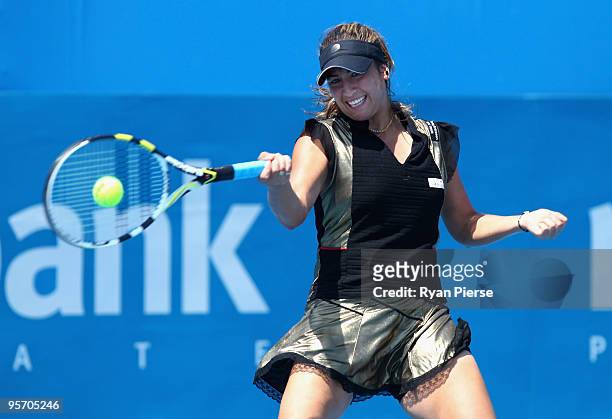 Aravane Rezai of France, wearing a gold dress, plays a forehand in her second round match against Agnes Szavay of Hungary during day three of the...