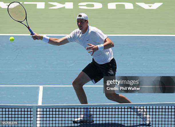John Isner of the USA plays a volley during his first round singles match against Guillermo Garcia-Lopez of Spain during day two of the Heineken Open...