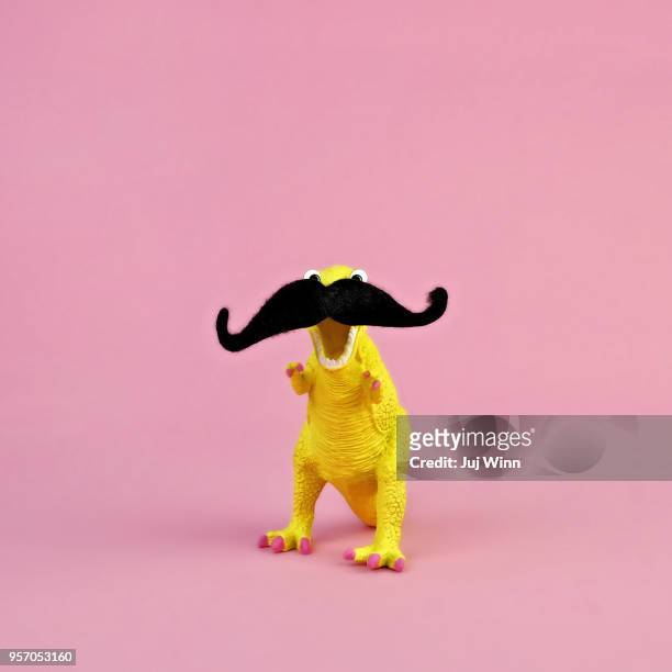 toy dinosaur with mustache - moustaches animales fotografías e imágenes de stock