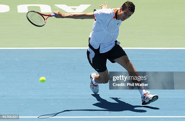 Guillermo Garcia-Lopez of Spain plays a backhand during his first round singles match against John Isner of the USA during day two of the Heineken...