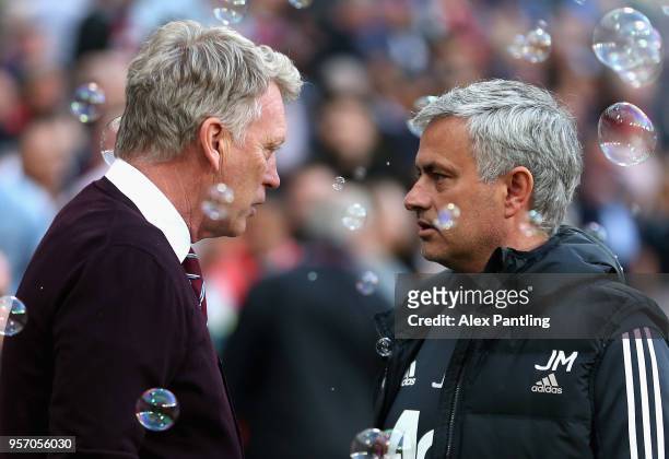 David Moyes, Manager of West Ham United and Jose Mourinho, Manager of Manchester United talk during the Premier League match between West Ham United...
