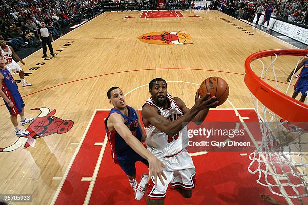 John Salmons of the Chicago Bulls shoots a layup against DaJuan Summers of the Detroit Pistons on January 11, 2010 at the United Center in Chicago,...