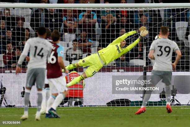 Manchester United's English midfielder Jesse Lingard watches as West Ham United's Spanish goalkeeper Adrian dives to save his shot during the English...