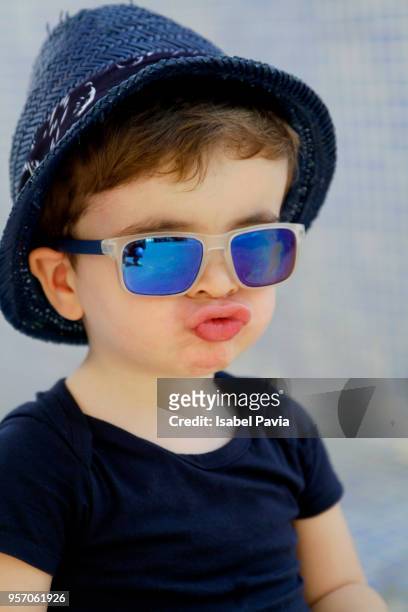portrait of cool baby boy sending kisses to camera. - isabel pavia stock-fotos und bilder