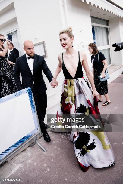 Amber Heard departs the Martinez Hotel during the 71st annual Cannes Film Festival at on May 10, 2018 in Cannes, France.