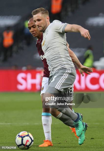 Luke Shaw of Manchester United in action with Joao Mario of West Ham United during the Premier League match between West Ham United and Manchester...