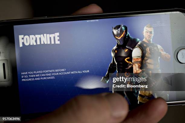 The Epic Games Inc. Fortnite: Battle Royale video game is displayed for a photograph on an Apple Inc. IPhone in Washington, D.C., U.S., on Thursday,...