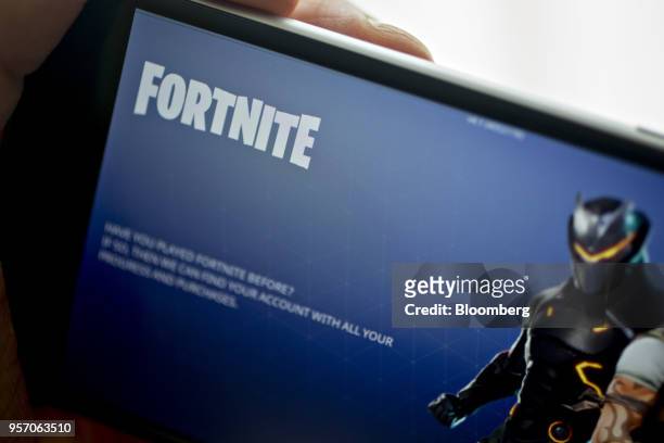 The Epic Games Inc. Fortnite: Battle Royale video game is displayed for a photograph on an Apple Inc. IPhone in Washington, D.C., U.S., on Thursday,...