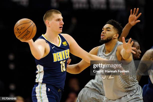 Karl-Anthony Towns of the Minnesota Timberwolves defends against Nikola Jokic of the Denver Nuggets during the game on April 11, 2018 at the Target...