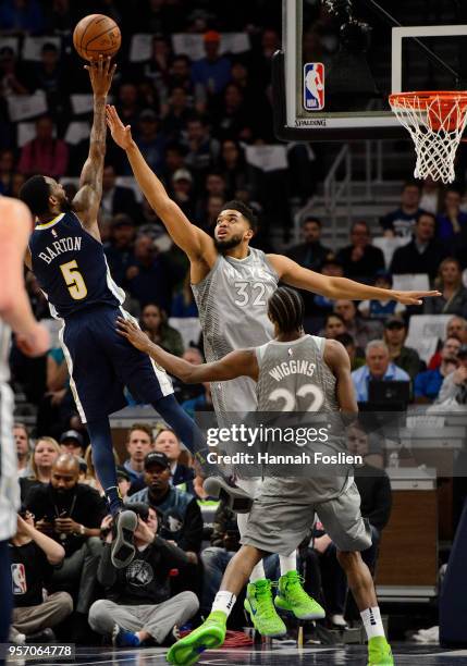 Will Barton of the Denver Nuggets shoots the ball against Karl-Anthony Towns and Andrew Wiggins of the Minnesota Timberwolves during the game on...