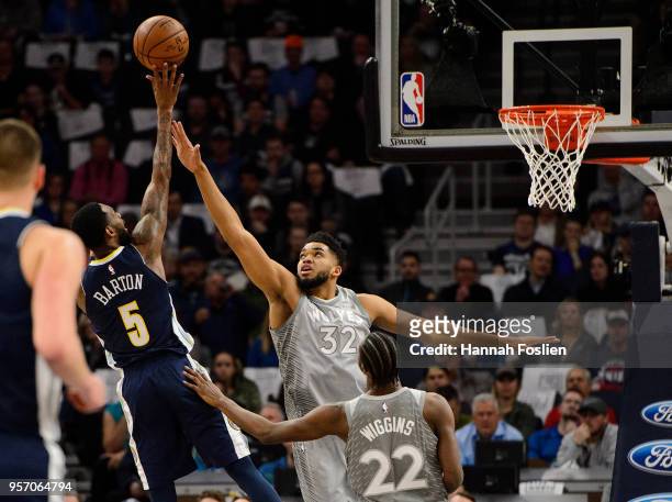 Will Barton of the Denver Nuggets shoots the ball against Karl-Anthony Towns and Andrew Wiggins of the Minnesota Timberwolves during the game on...