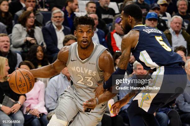 Jimmy Butler of the Minnesota Timberwolves drives to the basket against Will Barton of the Denver Nuggets during the game on April 11, 2018 at the...