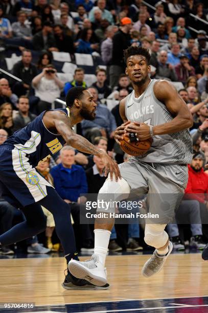 Jimmy Butler of the Minnesota Timberwolves drives to the basket against Will Barton of the Denver Nuggets during the game on April 11, 2018 at the...