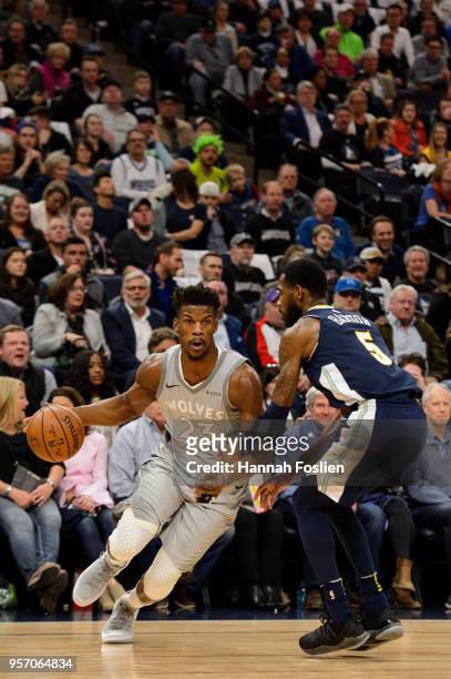 Jimmy Butler of the Minnesota Timberwolves drives to the basket against Will Barton of the Denver Nuggets during the game on April 11, 2018 at the...