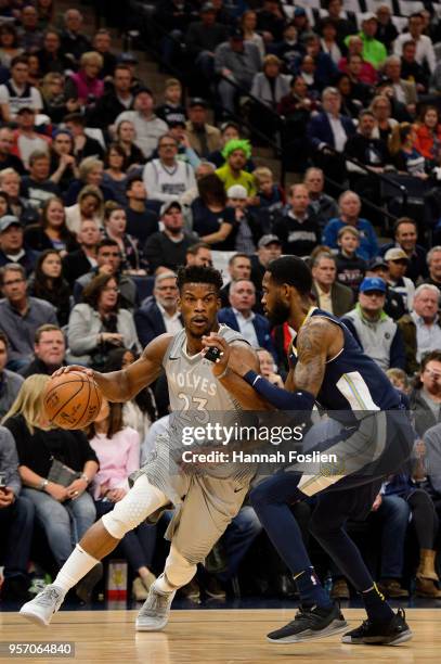 Jimmy Butler of the Minnesota Timberwolves drives to the basket against Will Barton of the Denver Nuggets during the game on April 11, 2018 at the...