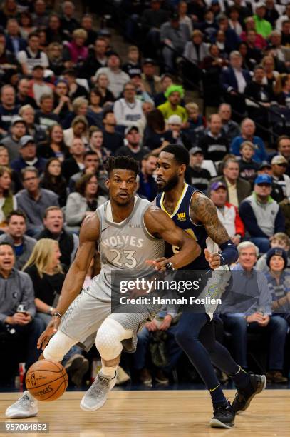 Jimmy Butler of the Minnesota Timberwolves drives to the basket against Will Barton of the Denver Nuggets during the game on April 11, 2018 at the...