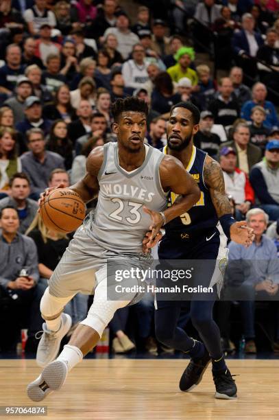 Jimmy Butler of the Minnesota Timberwolves drives to the basket against Will Barton of the Denver Nuggets during the game on April 11, 2018 at the...