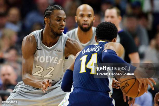 Andrew Wiggins of the Minnesota Timberwolves defends against Gary Harris of the Denver Nuggets during the game on April 11, 2018 at the Target Center...
