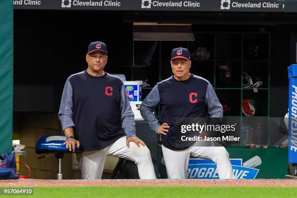 Manager Terry Francona and bench coach Brad Mills of the Cleveland Indians watch from the dugout during the game against the Toronto Blue Jays in...