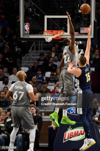 Andrew Wiggins of the Minnesota Timberwolves looks to blocks a shot by Nikola Jokic of the Denver Nuggets during the game on April 11, 2018 at the...