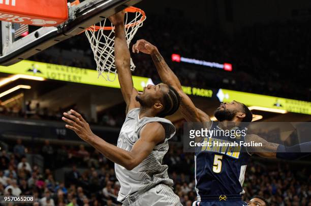 Andrew Wiggins of the Minnesota Timberwolves shoots the ball against Will Barton of the Denver Nuggets during the game on April 11, 2018 at the...