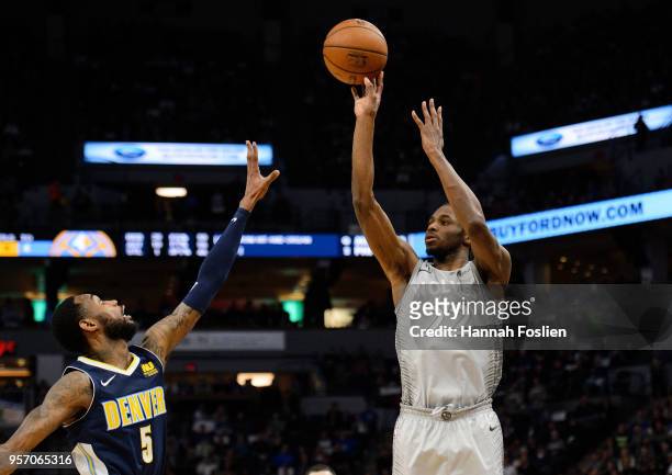 Andrew Wiggins of the Minnesota Timberwolves shoots the ball against Will Barton of the Denver Nuggets during the game on April 11, 2018 at the...