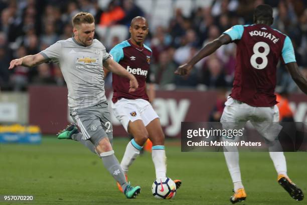 Luke Shaw of Manchester United in action with Joao Mario and Cheikhou Kouyate of West Ham United during the Premier League match between West Ham...